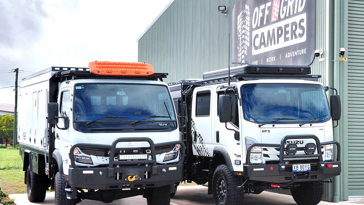 Single-Cab Truck Camper in front of premises