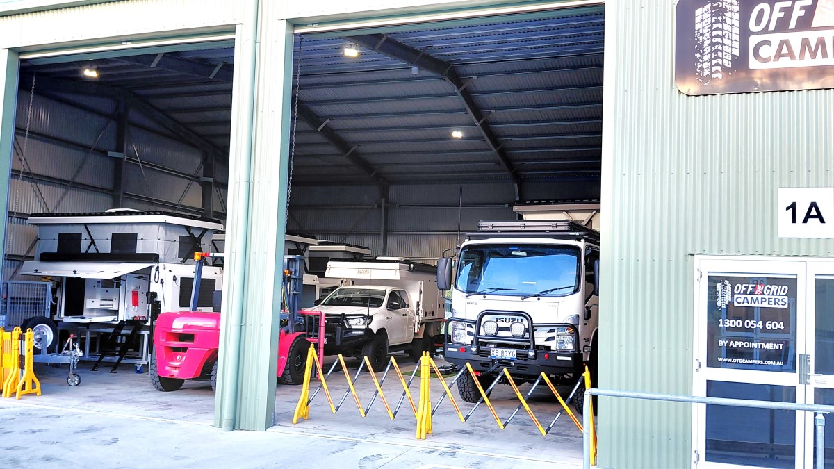 Single-Cab Truck Camper in front of premises