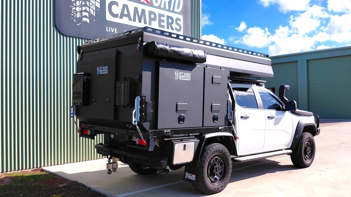Single-Cab Truck Camper in front of premises